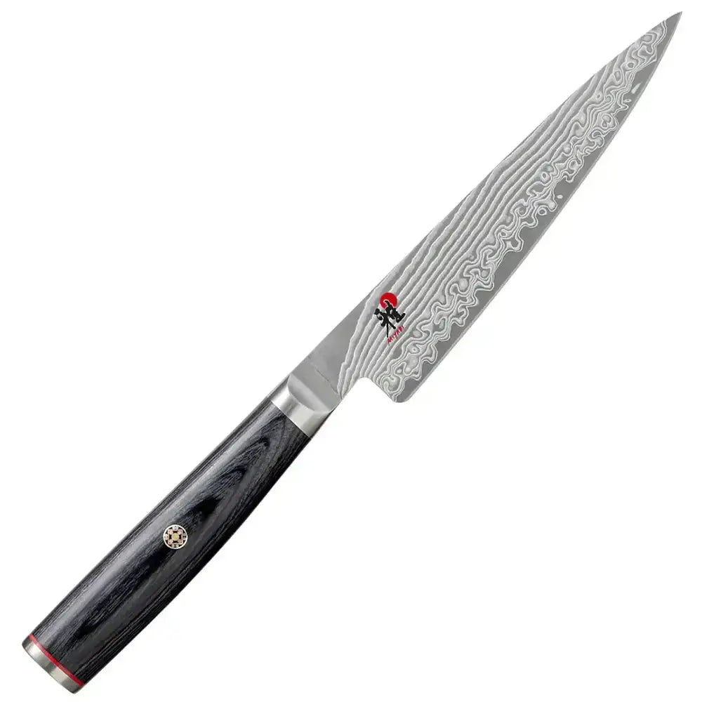 Chef's knife with a decorative blade and black handle on a white background