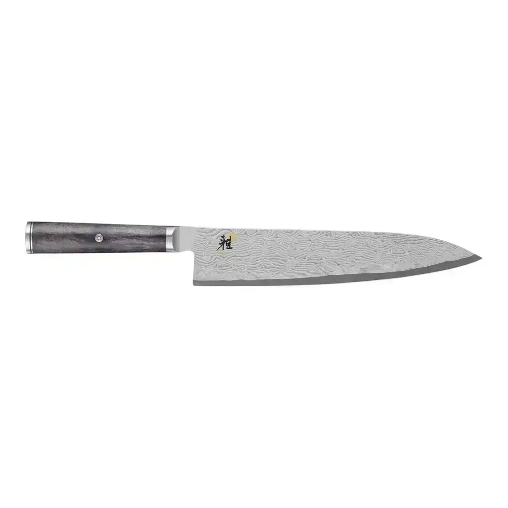 Chef's knife with a textured blade and wooden handle on a white background