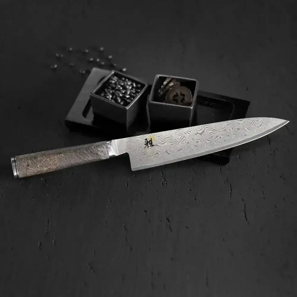 Decorative knife with engraved details on a dark surface