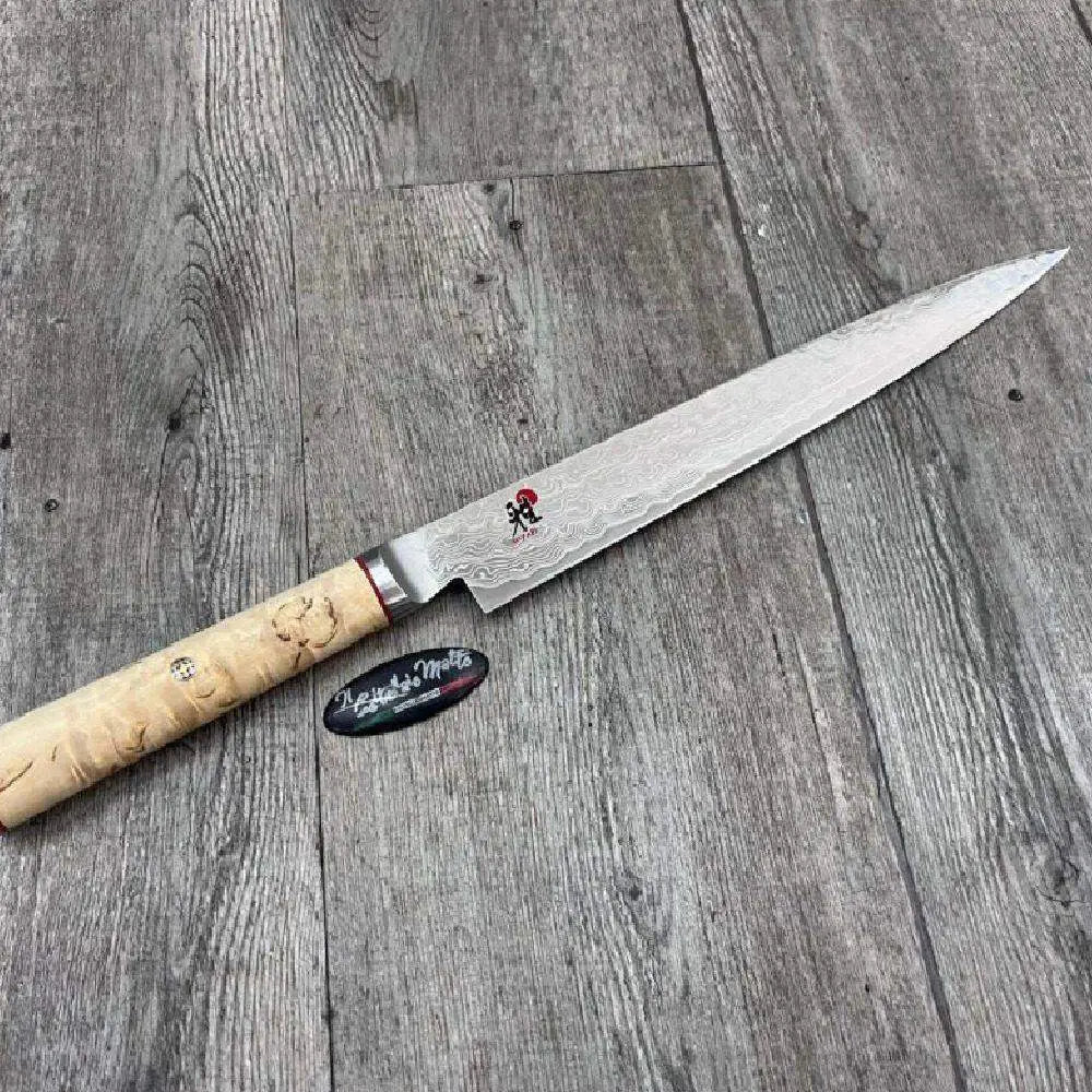 Knife with a wooden handle on a wooden surface