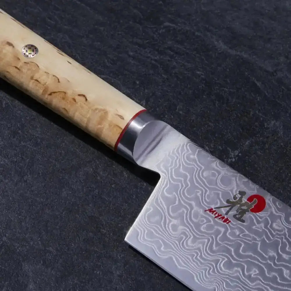 Japanese knife with a wooden handle on a dark surface
