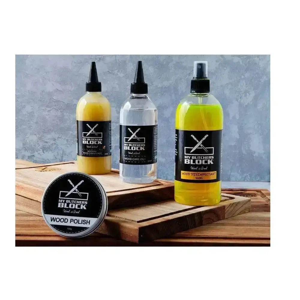 Three bottles of 'My Butcher's Block' wood polish on a wooden surface with a gray background.