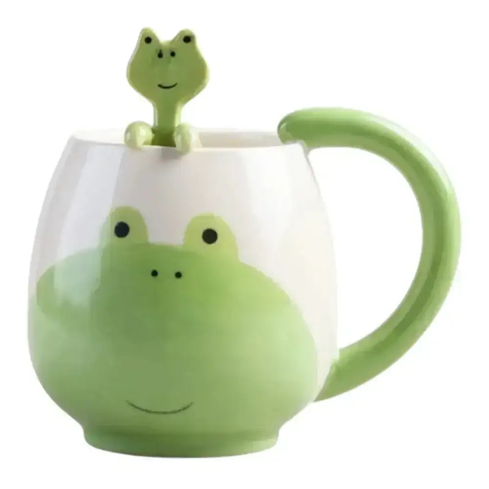 Green frog-themed mug with a smaller frog figure on top against a white background
