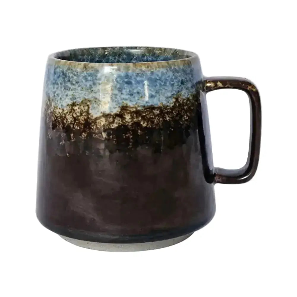 Ceramic mug with a gradient design from blue to black on a white background