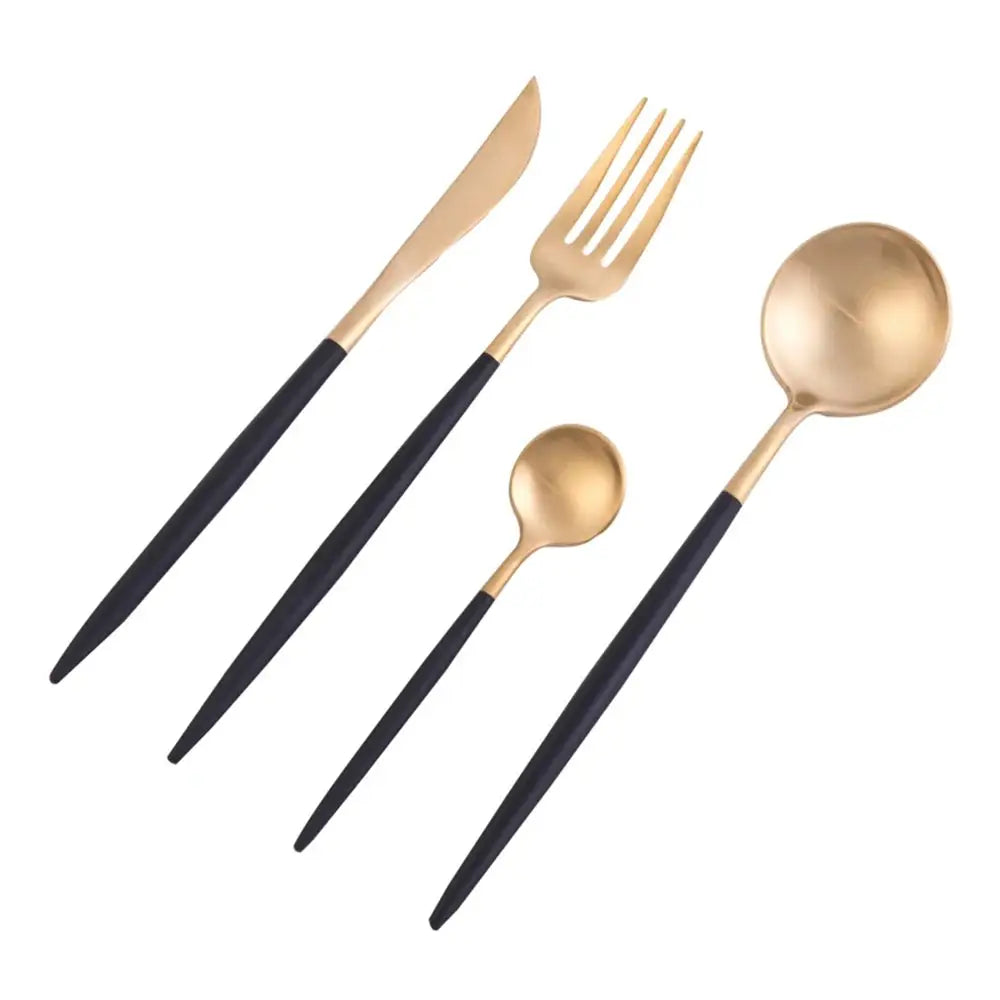 Set of gold and black cutlery on a white background