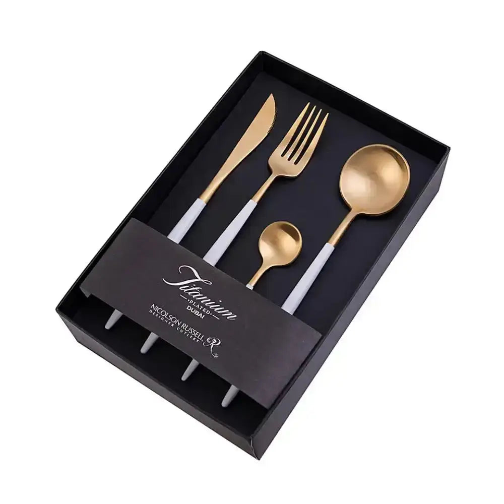 Set of gold cutlery including knife, fork, and spoons in a black box with branding.