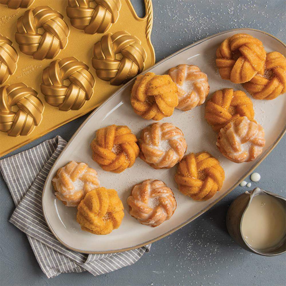 Braided mini Bundt cakes on platter with gold Nordic Ware baking pan, Cookin Stores kitchenware