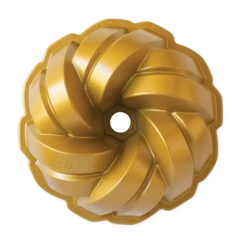 Gold Bundt cake pan on a white background