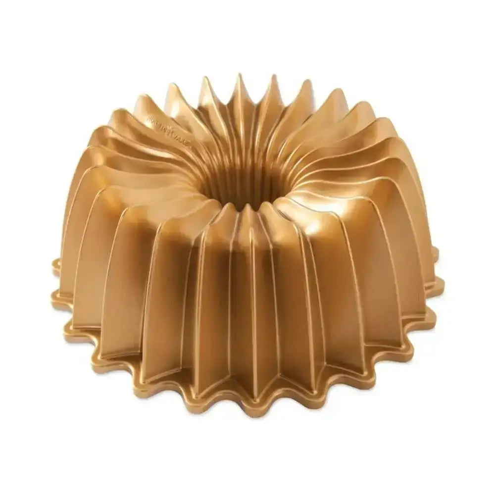 Gold Bundt cake mold on a white background