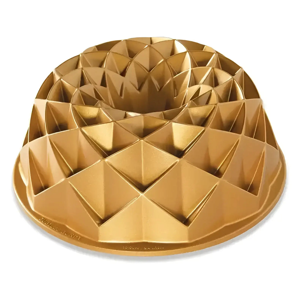 Gold bundt cake mold on a white background