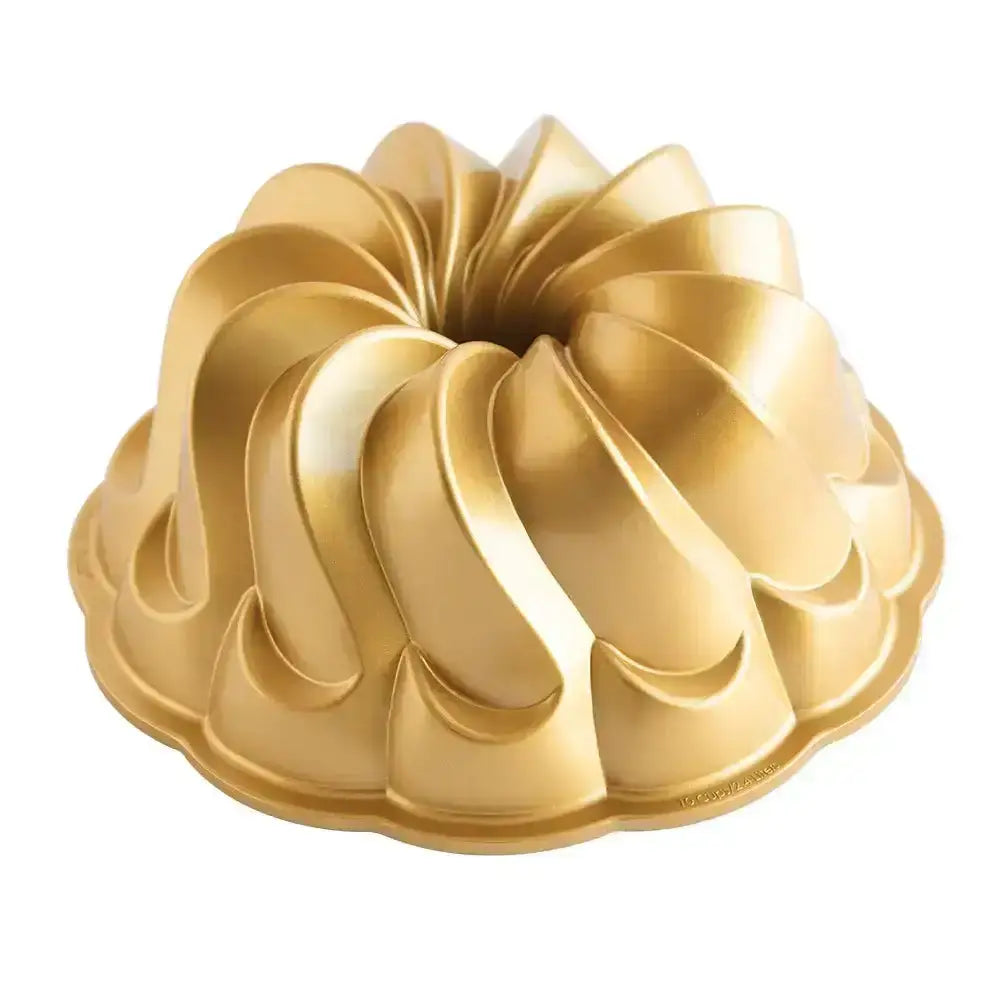 Gold Bundt cake mold on a white background