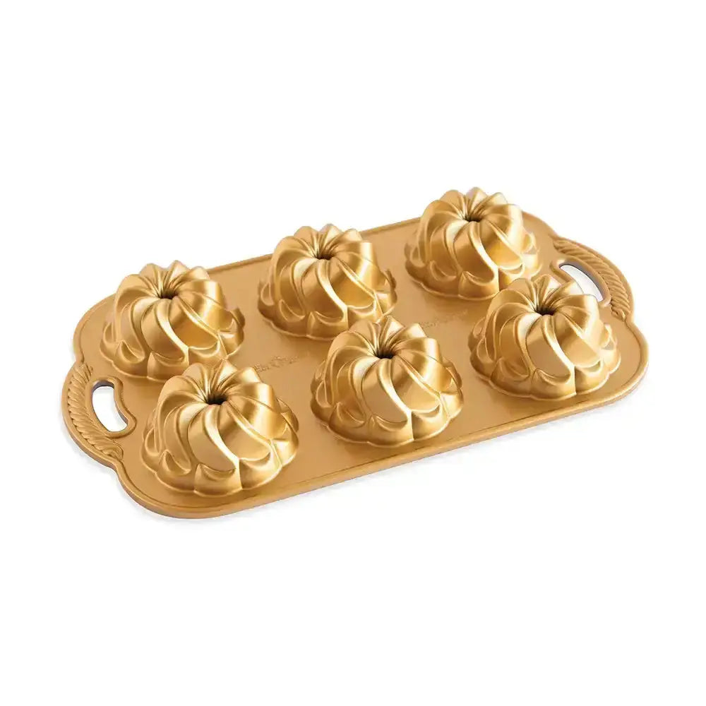 Gold Bundt cake mold on a white background