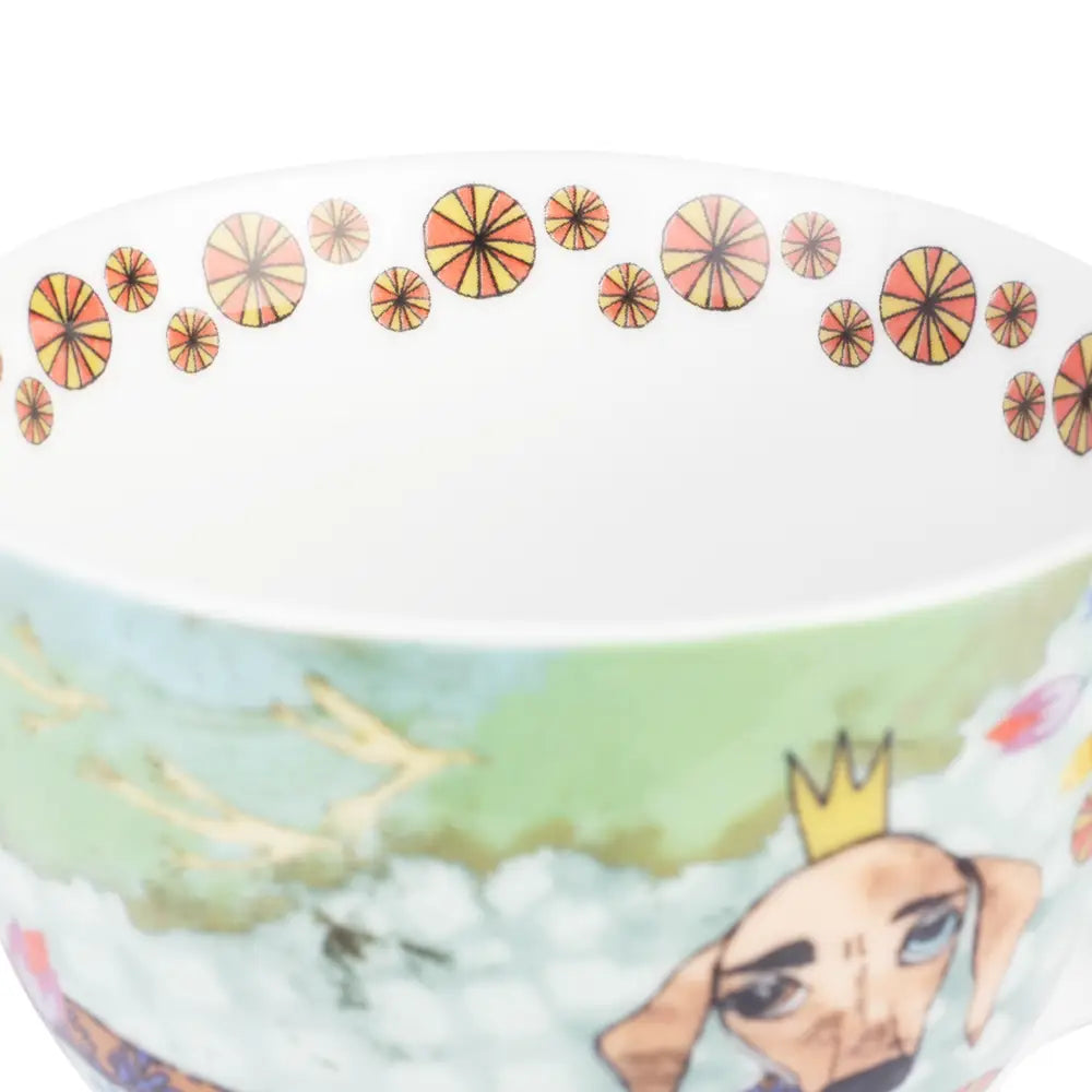 Ceramic bowl with a colorful design of a character with a crown and a landscape.