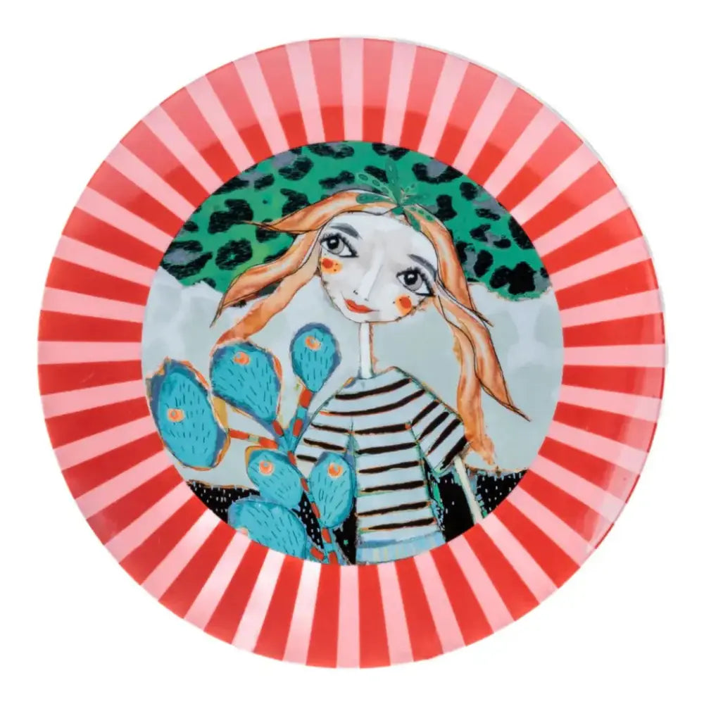 Decorative plate with a colorful design of a woman, cactus, and leopard print on a red and pink striped background.