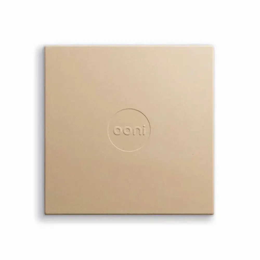 Beige Ooni pizza stone on a white background