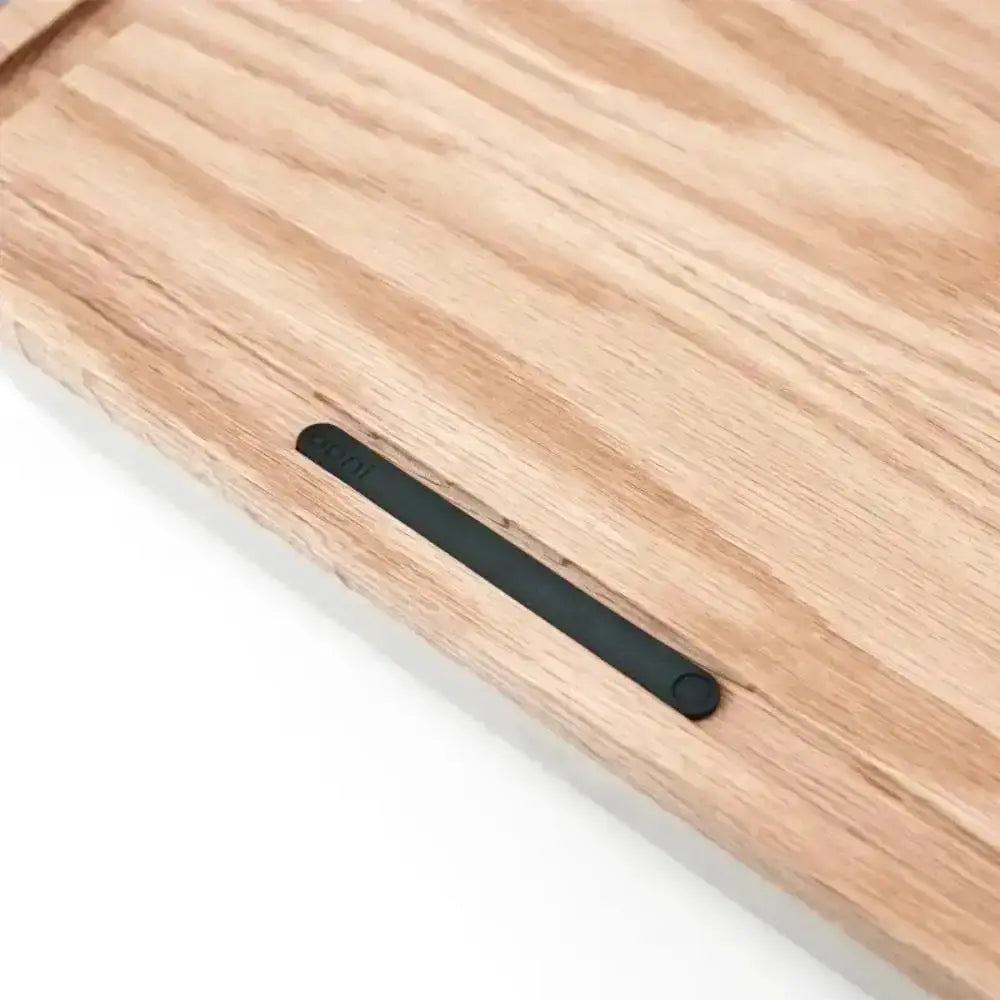 Wooden cutting board with a black handle on a white background