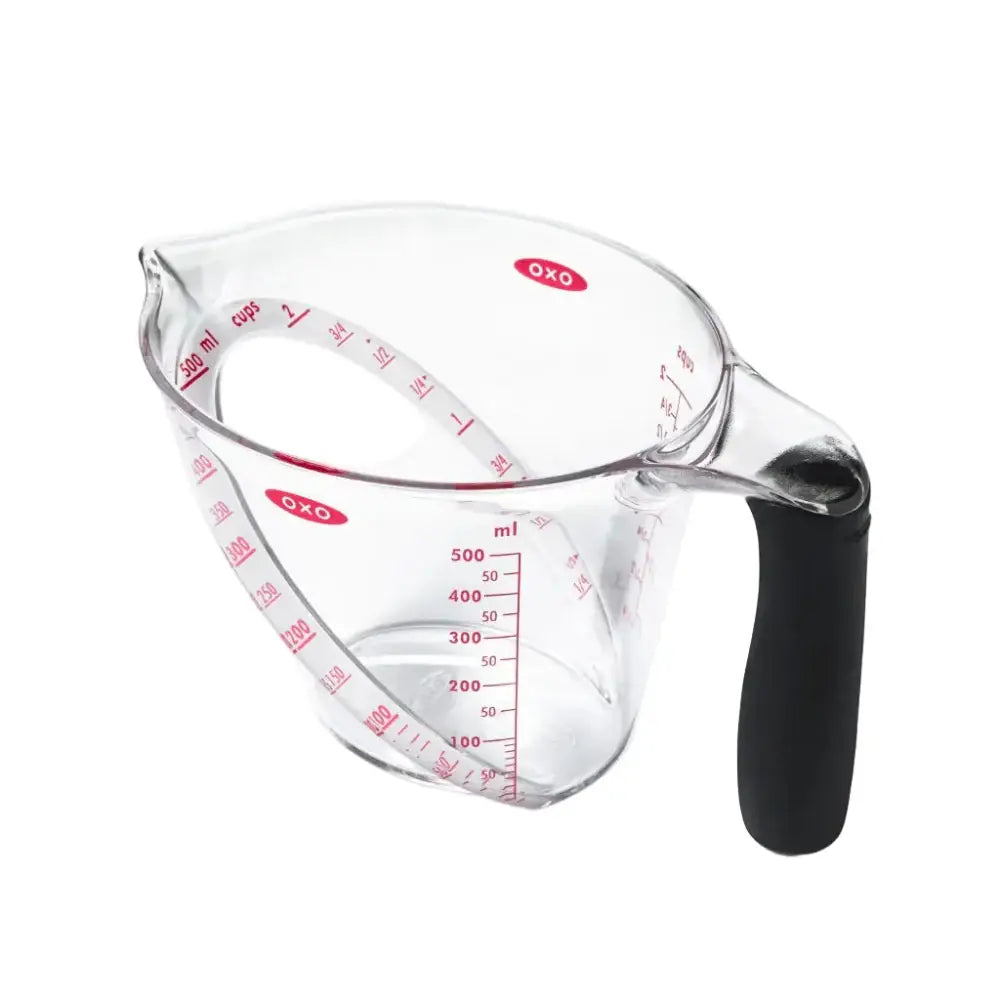 Clear glass oxo good grips angled measuring jug 2-cup with black silicone handle and red measurement markings