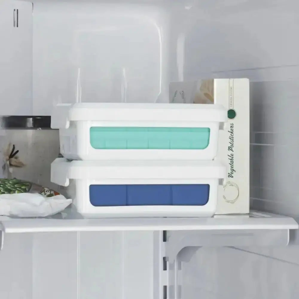 Stackable storage containers with blue and green lids inside a refrigerator.