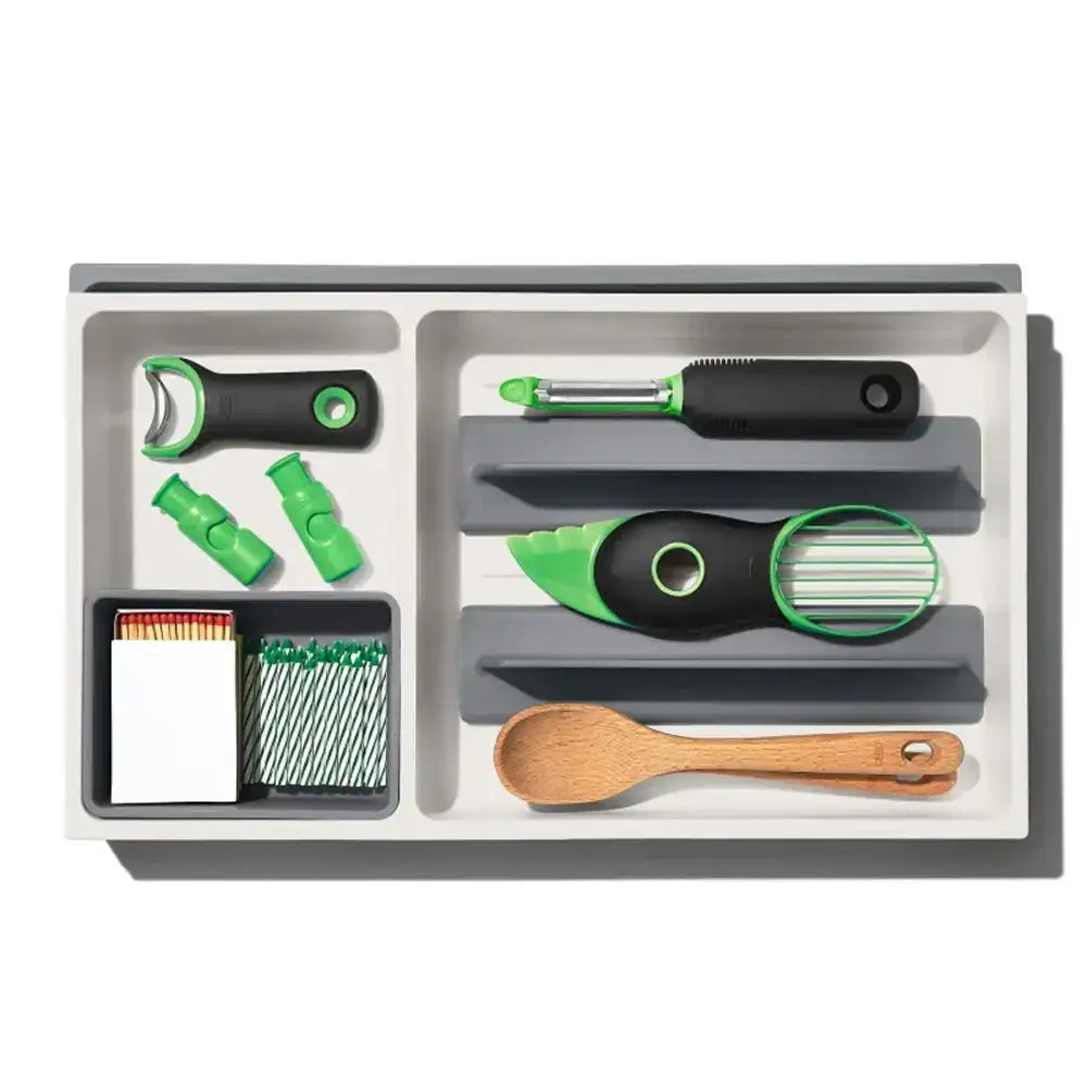 Set of kitchen utensils including a bottle opener, peeler, and wooden spoon on a white background