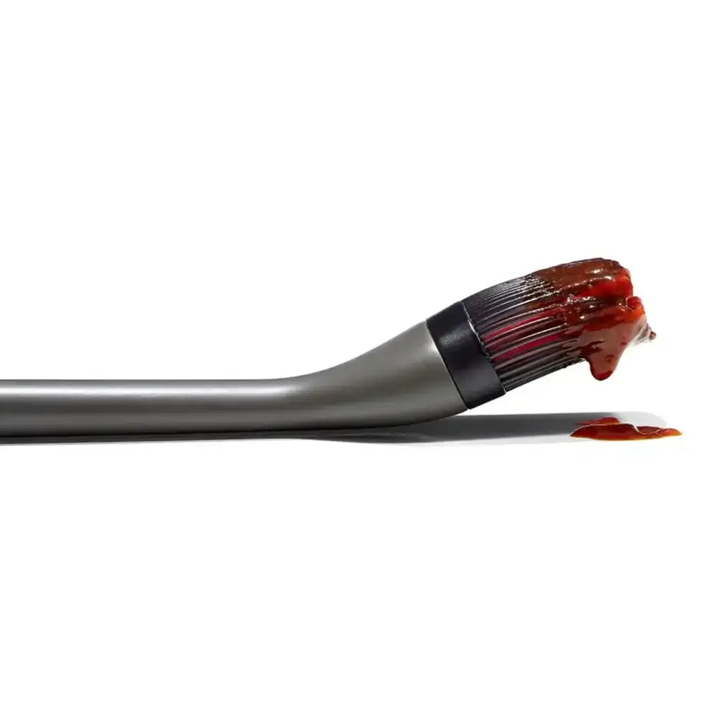 Brush with brown liquid residue on a white background