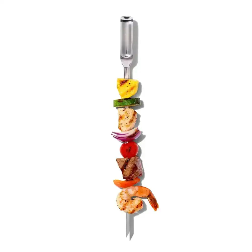 Metallic skewer with assorted vegetables on a white background