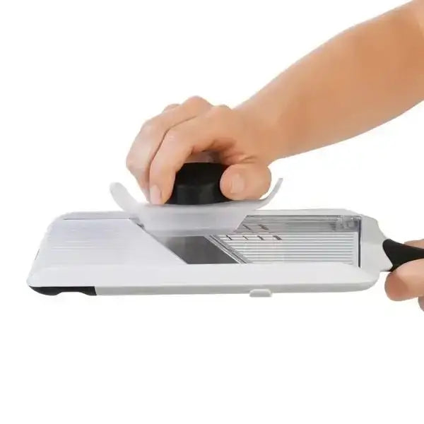 Person using a knife sharpener on a white background