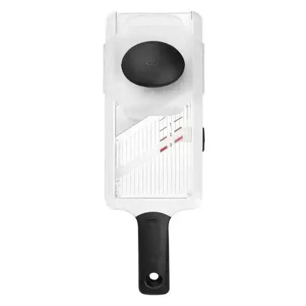 White vegetable slicer with black handle on a white background