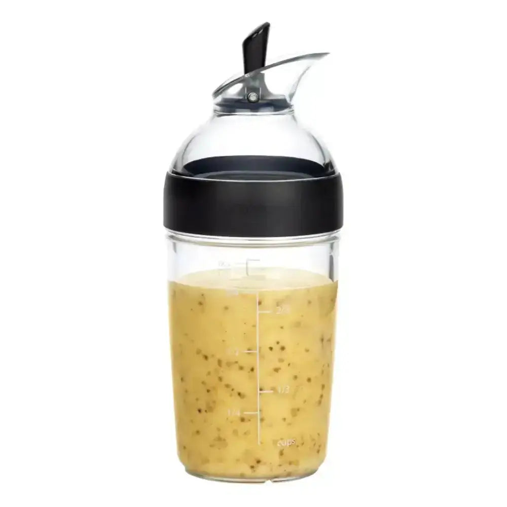 Clear bottle with black cap containing a yellowish liquid on a white background