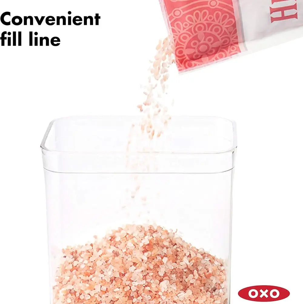 Clear container with pink Himalayan salt being poured, OXO logo visible