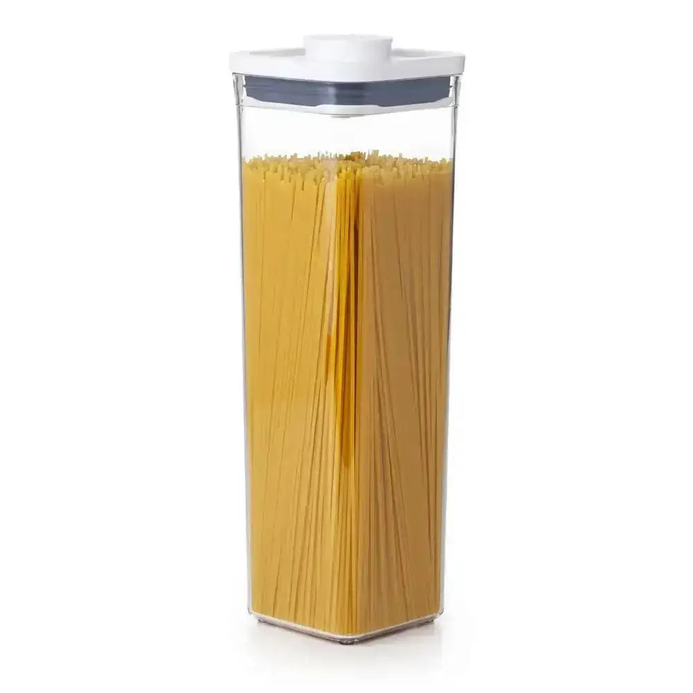 Container filled with spaghetti on a white background