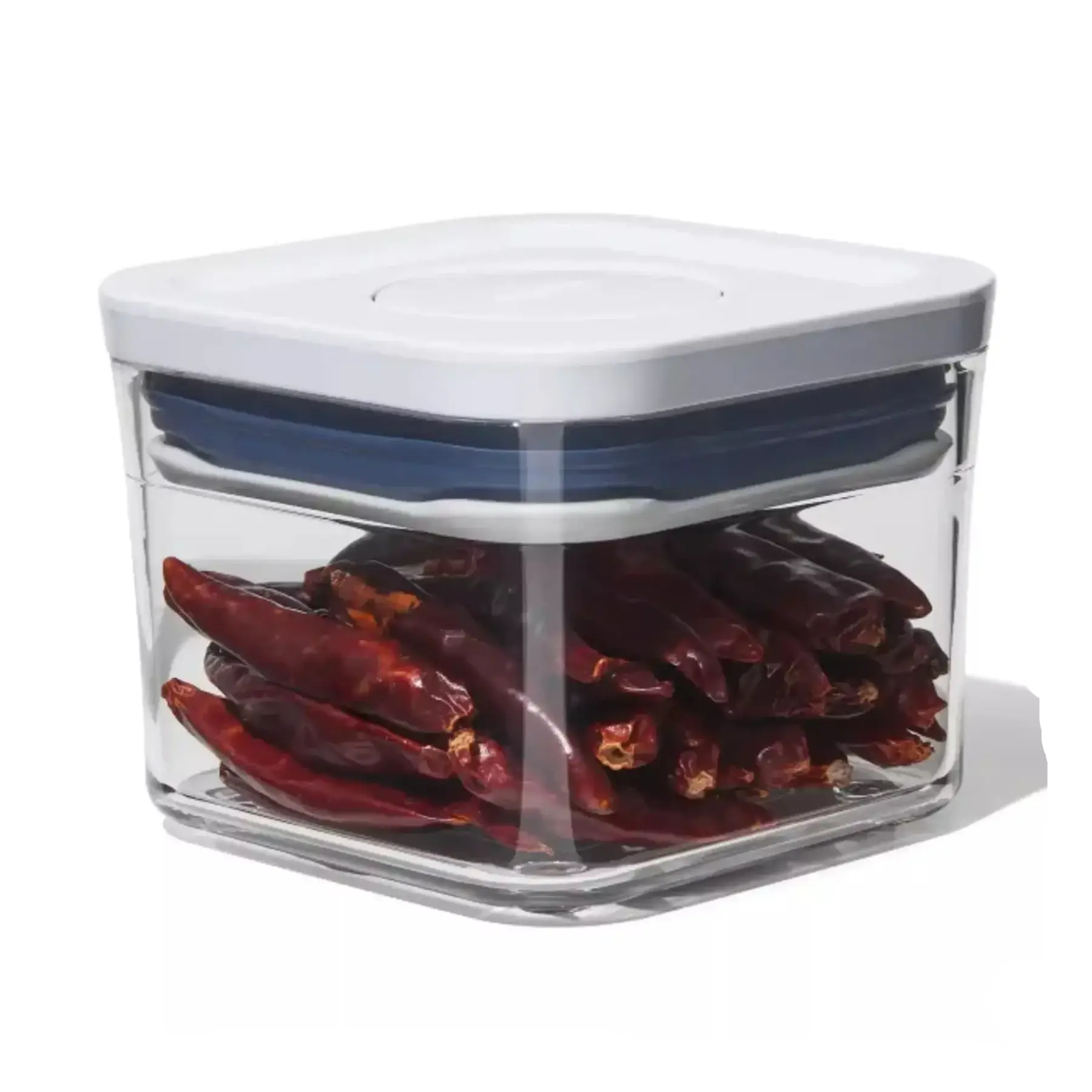 Clear container with red peppers inside on a white background