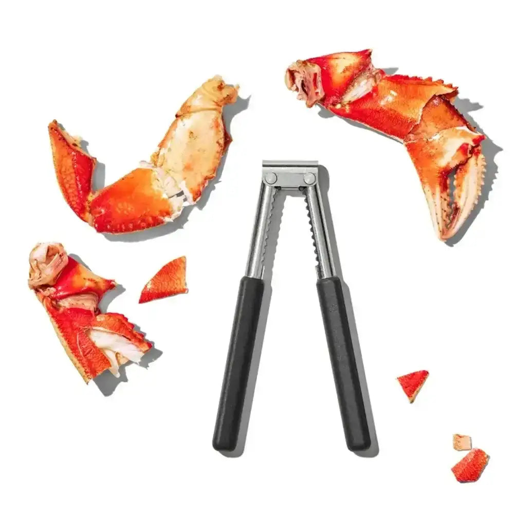 Crab legs with a crab leg opener on a white background