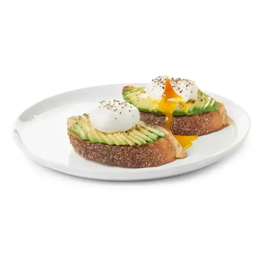 Avocado toast with poached eggs on a white plate