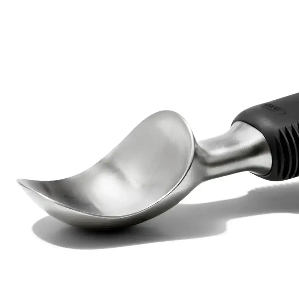 Stainless steel ice cream scoop with black handle on a white background