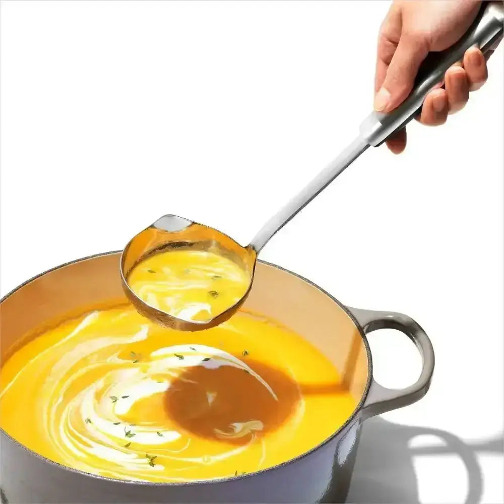 Oxo good grips stainless steel soup ladle with long handle scooping golden soup from a pot