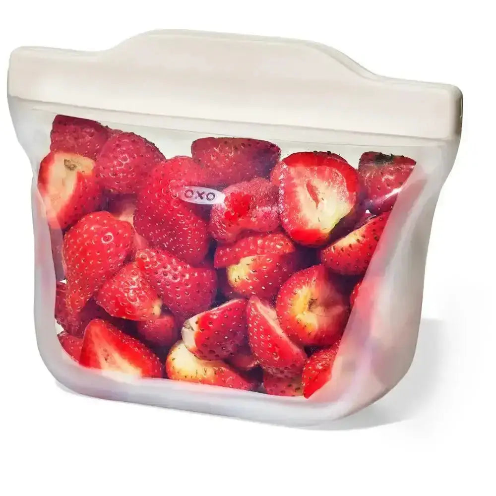 Oxo good grips stand up transparent silicone resealable bag with white seal strip filled with fresh red strawberries