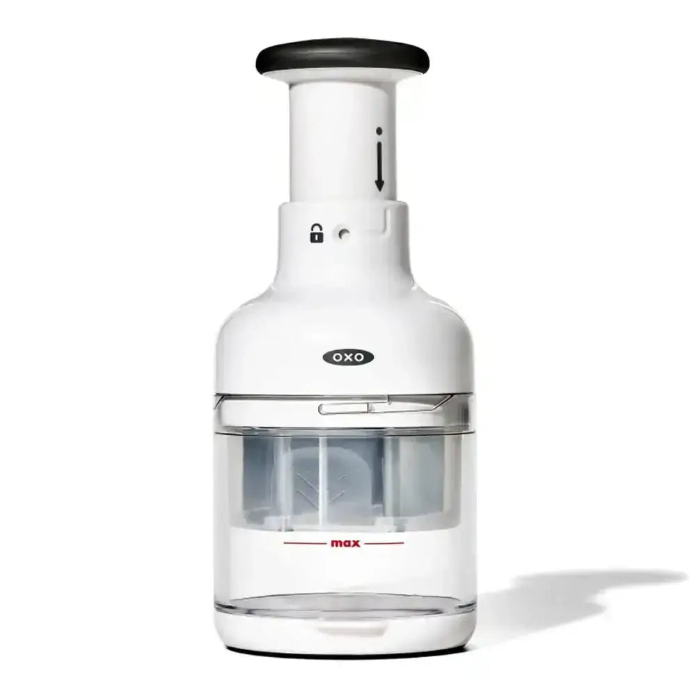 OXO kitchen tool with white body and clear container on a white background