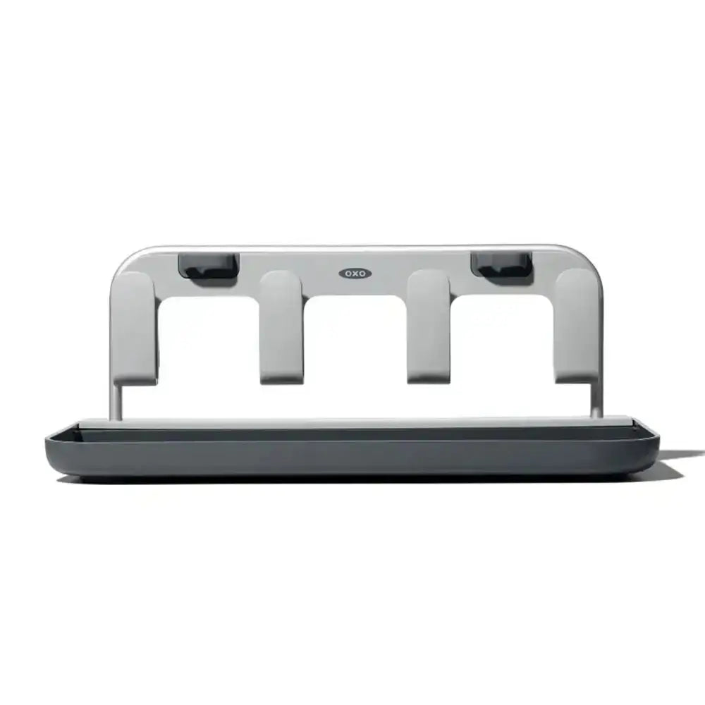 Gray kitchen utensil holder with three vertical holders on a white background