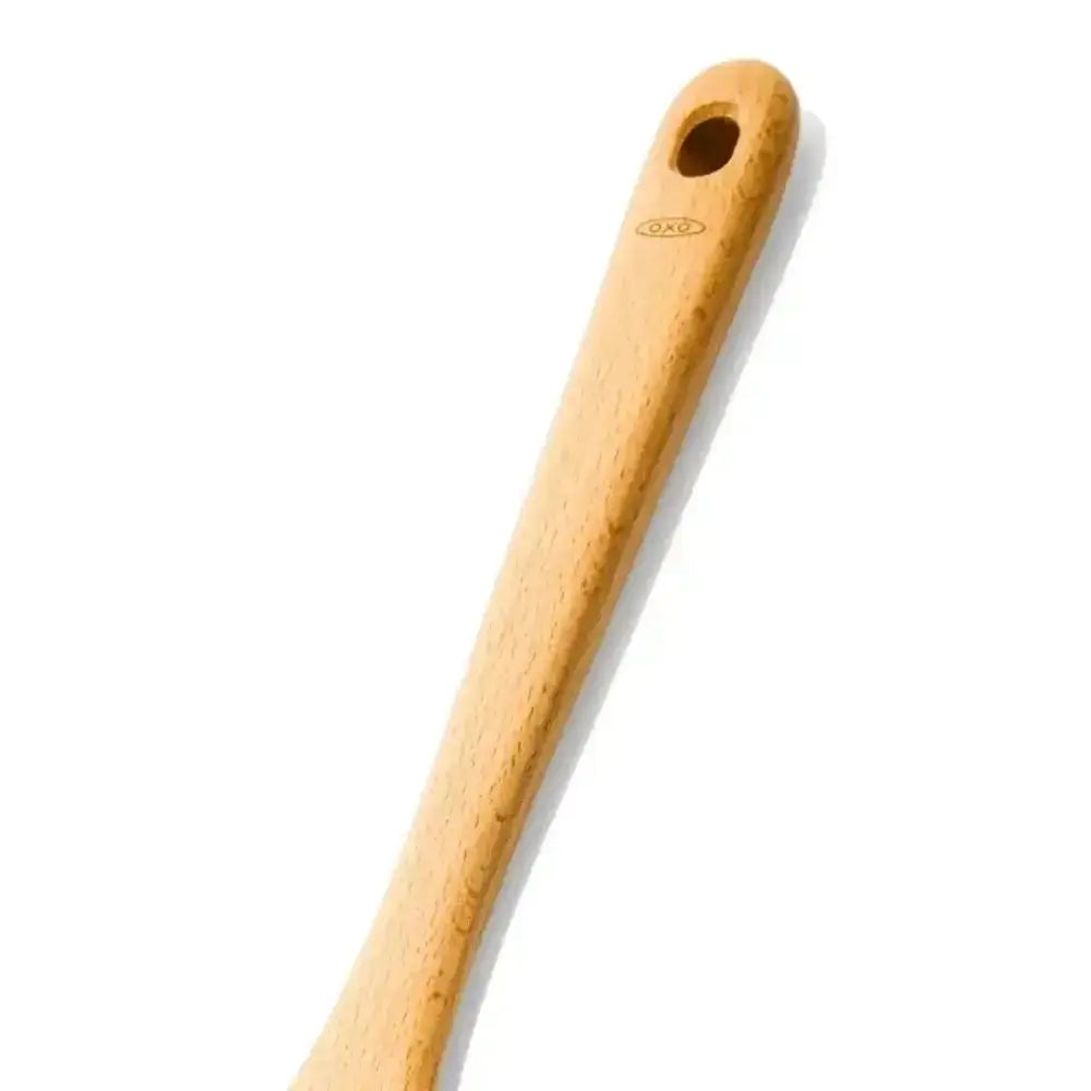 Wooden spoon with a hole in the handle on a white background