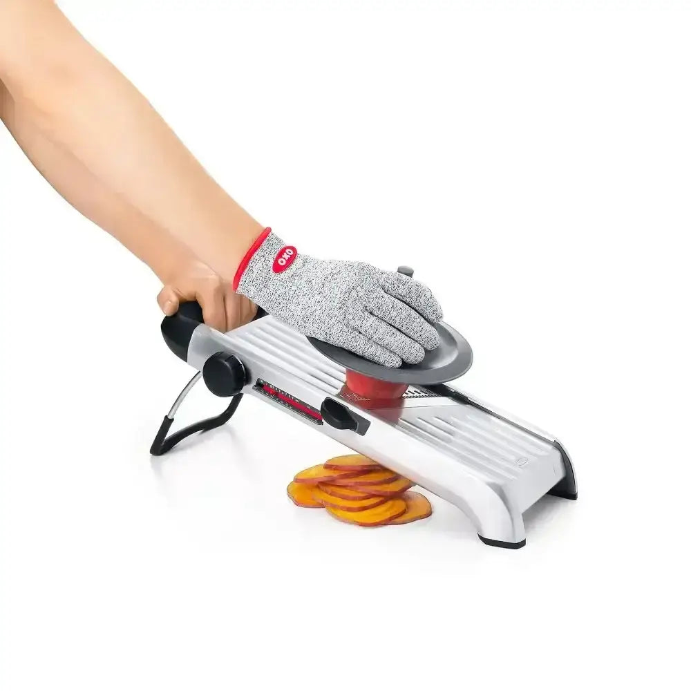 Oxo stainless steel chef’s mandoline slicer 2.0 silver and black with red handle slicing orange fruit