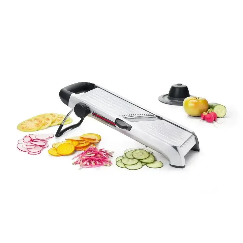 Oxo stainless steel chef’s mandoline slicer 2.0 silver and black with interchangeable blades and sliced vegetables nearby
