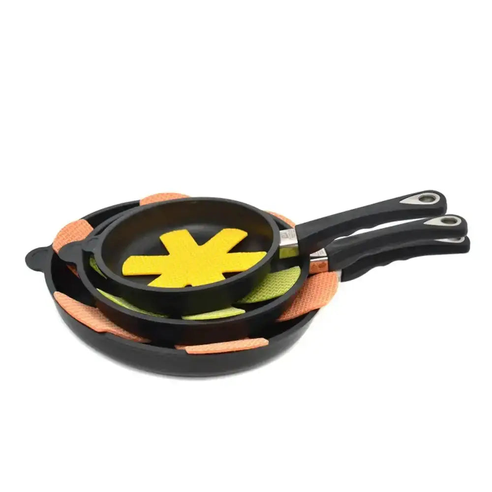 Set of frying pans with colorful handles on a white background