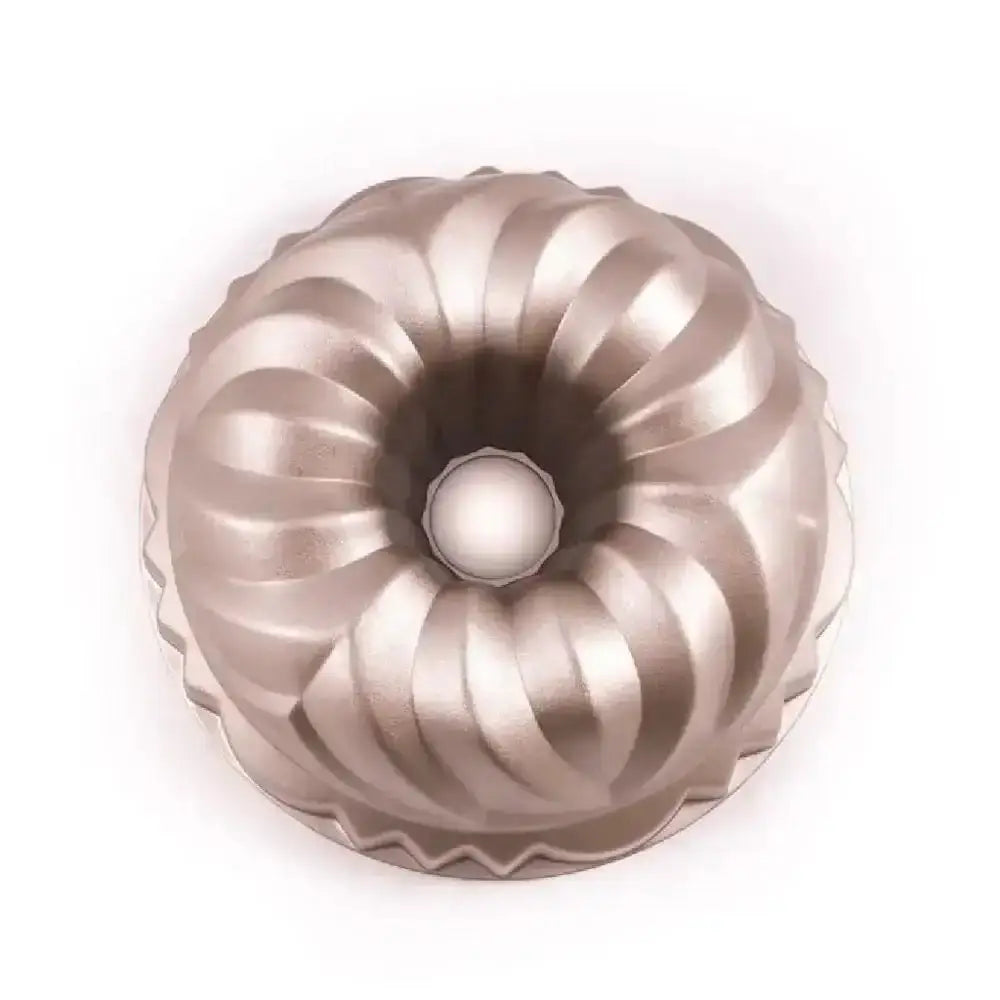 Metallic Bundt cake mold on a white background