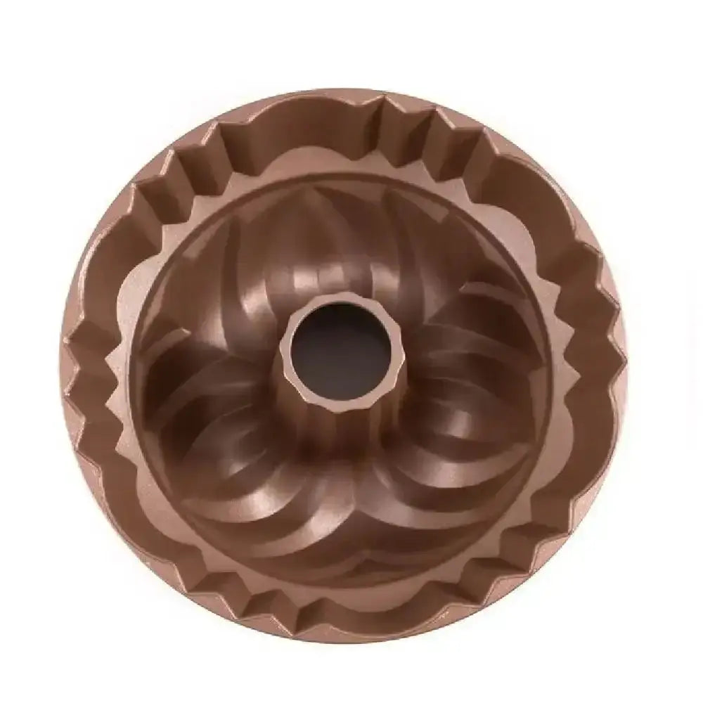 Bronze bundt cake mold on a white background