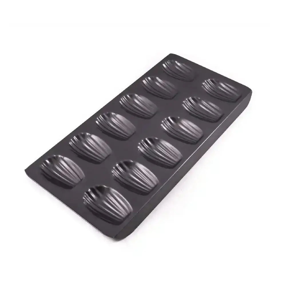 Black madeleine cake mold on a white background