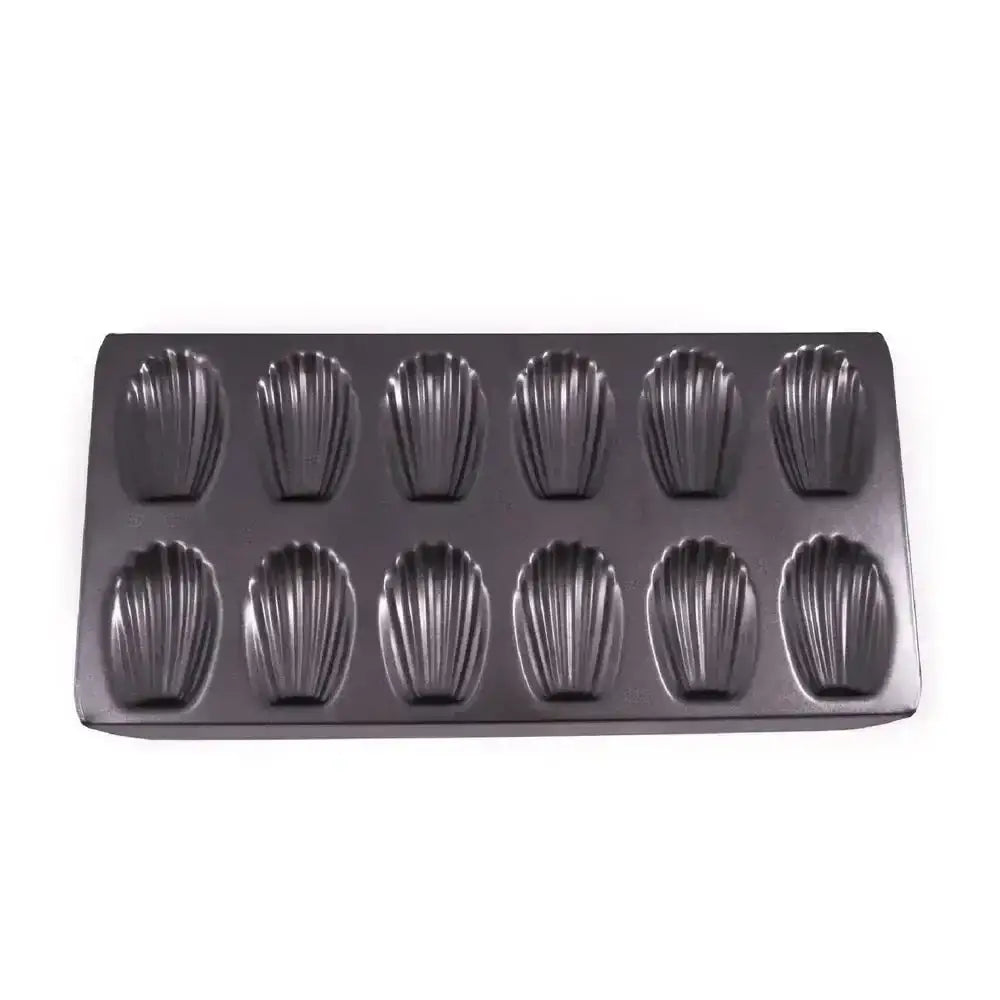 Metallic muffin tray with shell-shaped molds on a white background