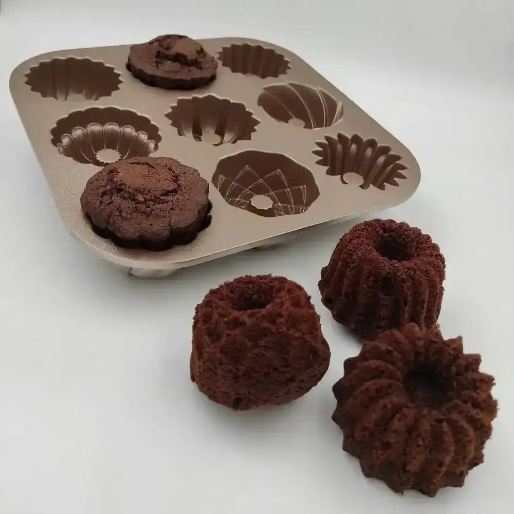 Bundt cake mold with baked bundt cakes on a white background