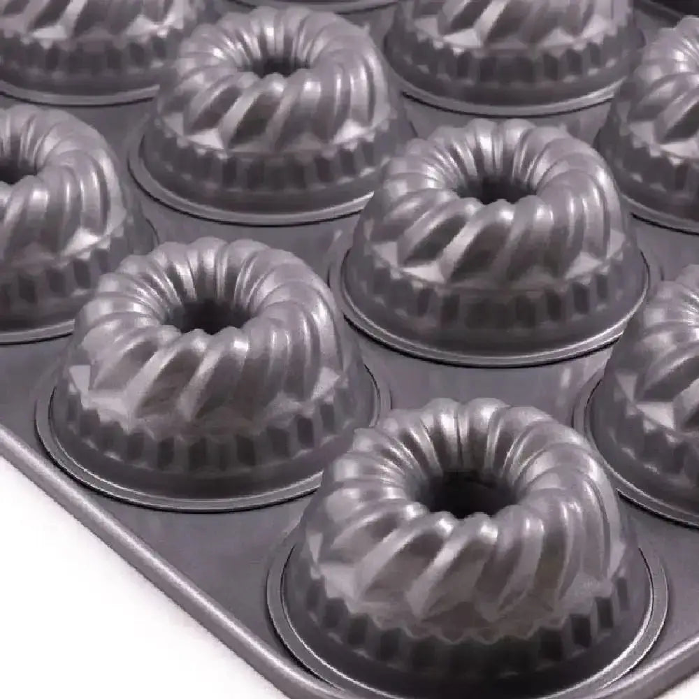 Metal Bundt cake pans arranged in a baking tray