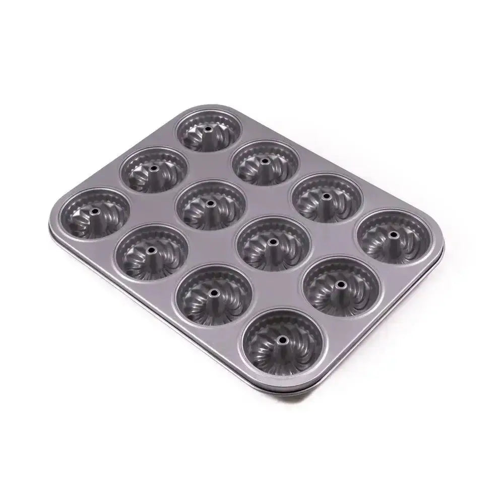Metal muffin tin with multiple compartments on a white background