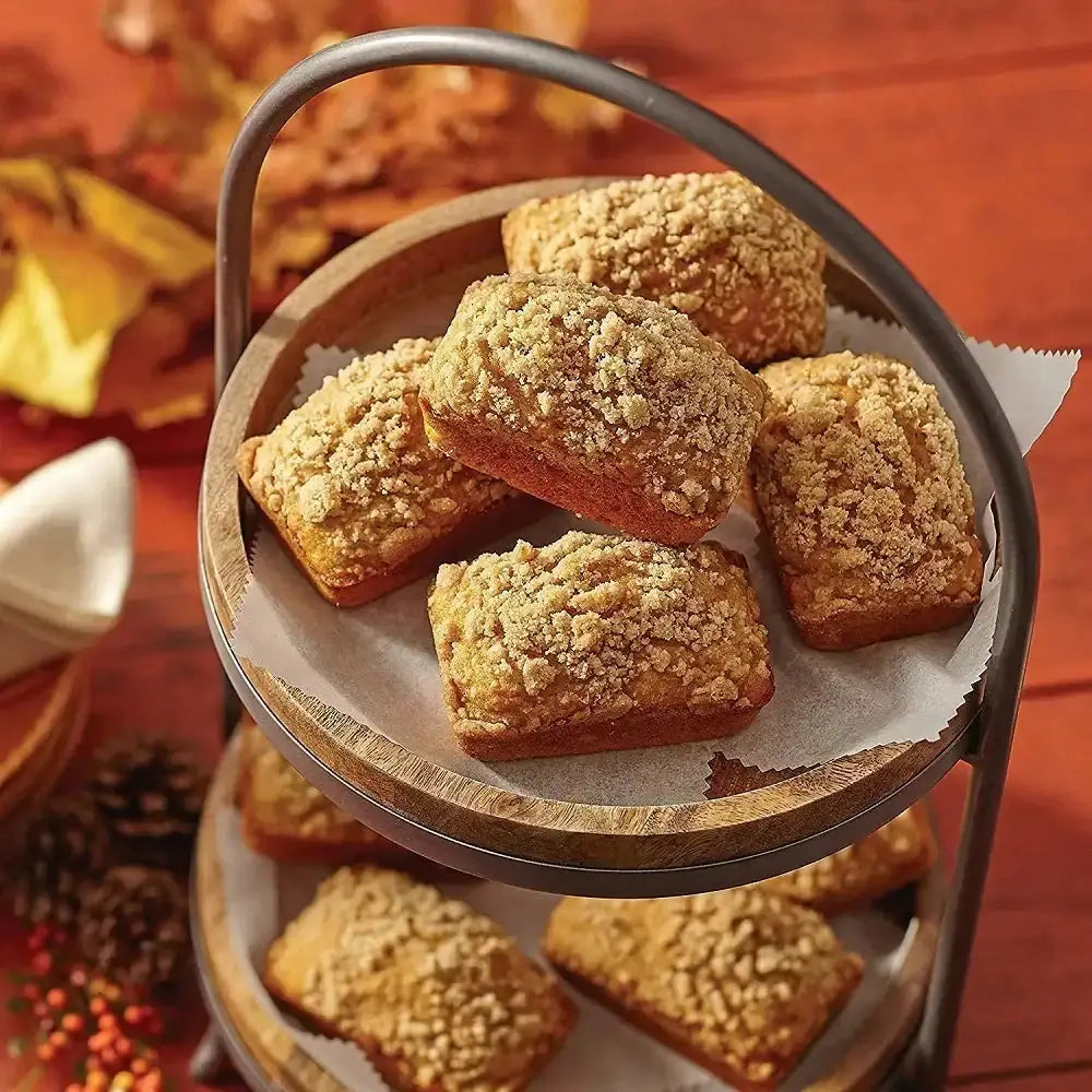 Baked goods on a tiered stand with a warm autumnal background